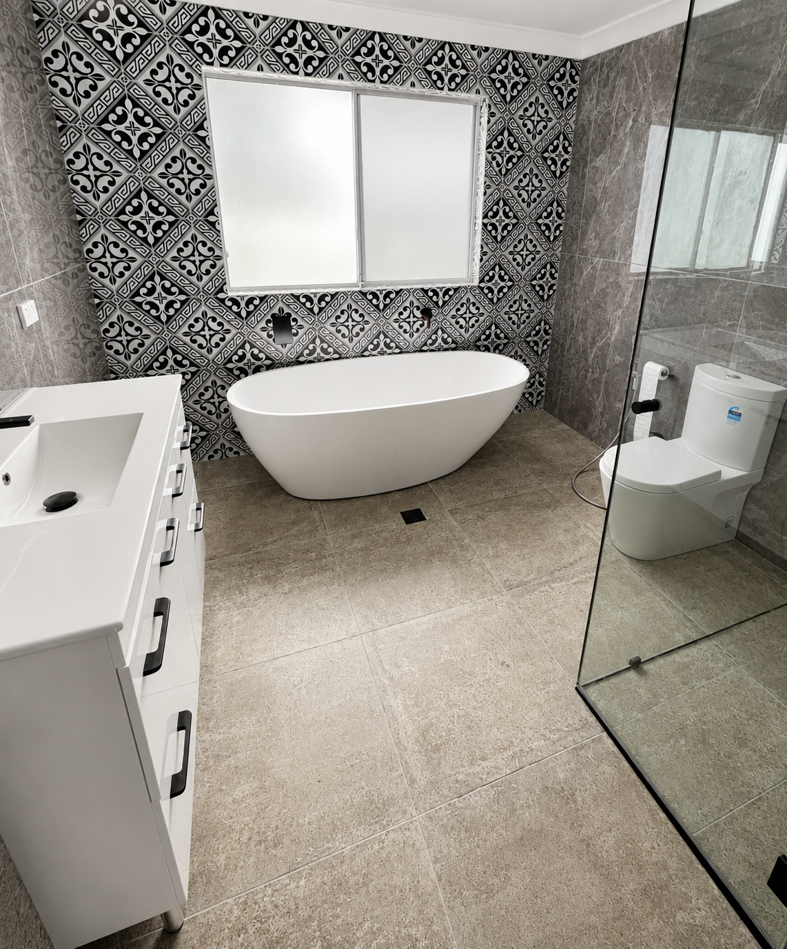 Completed main bathroom with freestanding bath, toilet and shower