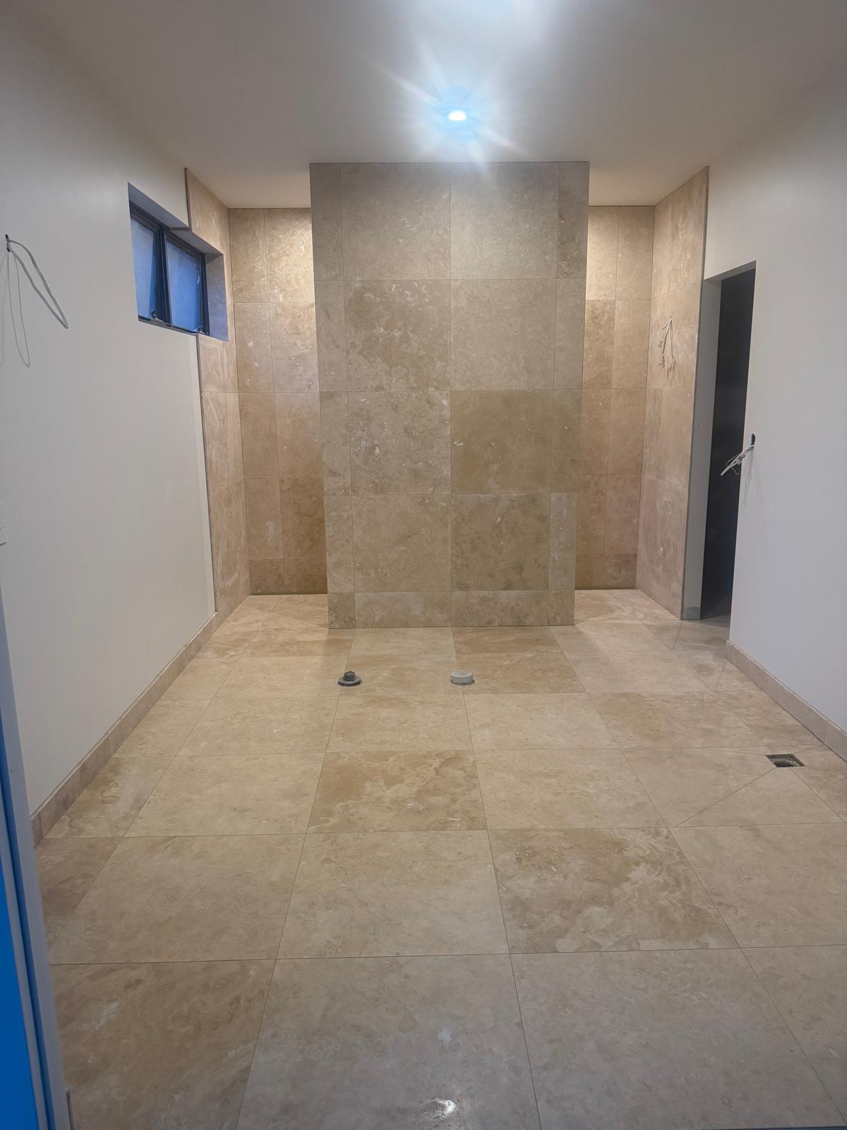 Travertine main bathroom tiling after