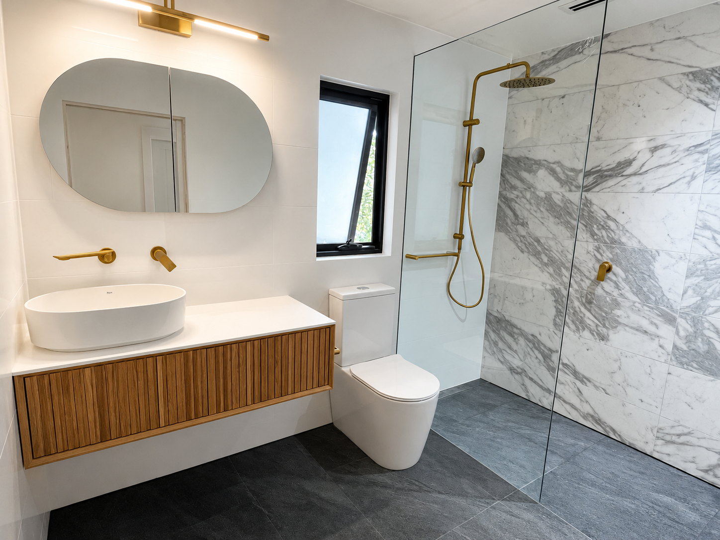 Completed marble ensuite with wood vanity and gold fixtures