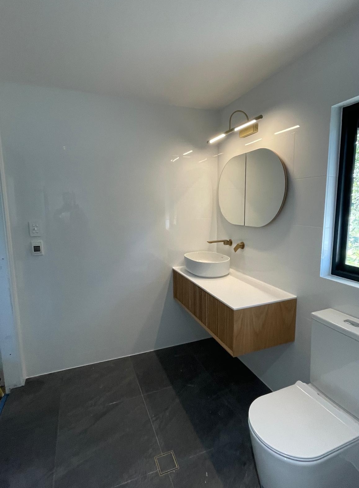 Completed ensuite bathroom with wood vanity