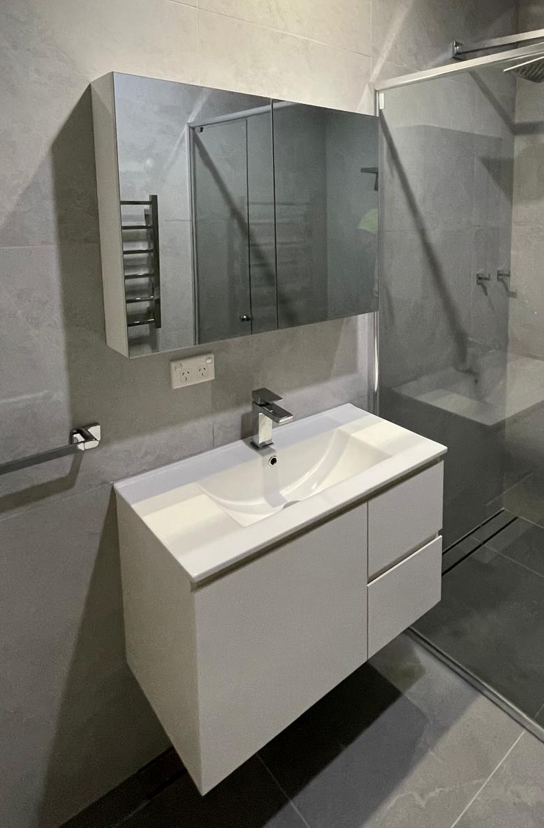 Completed small ensuite grey bathroom with floating vanity