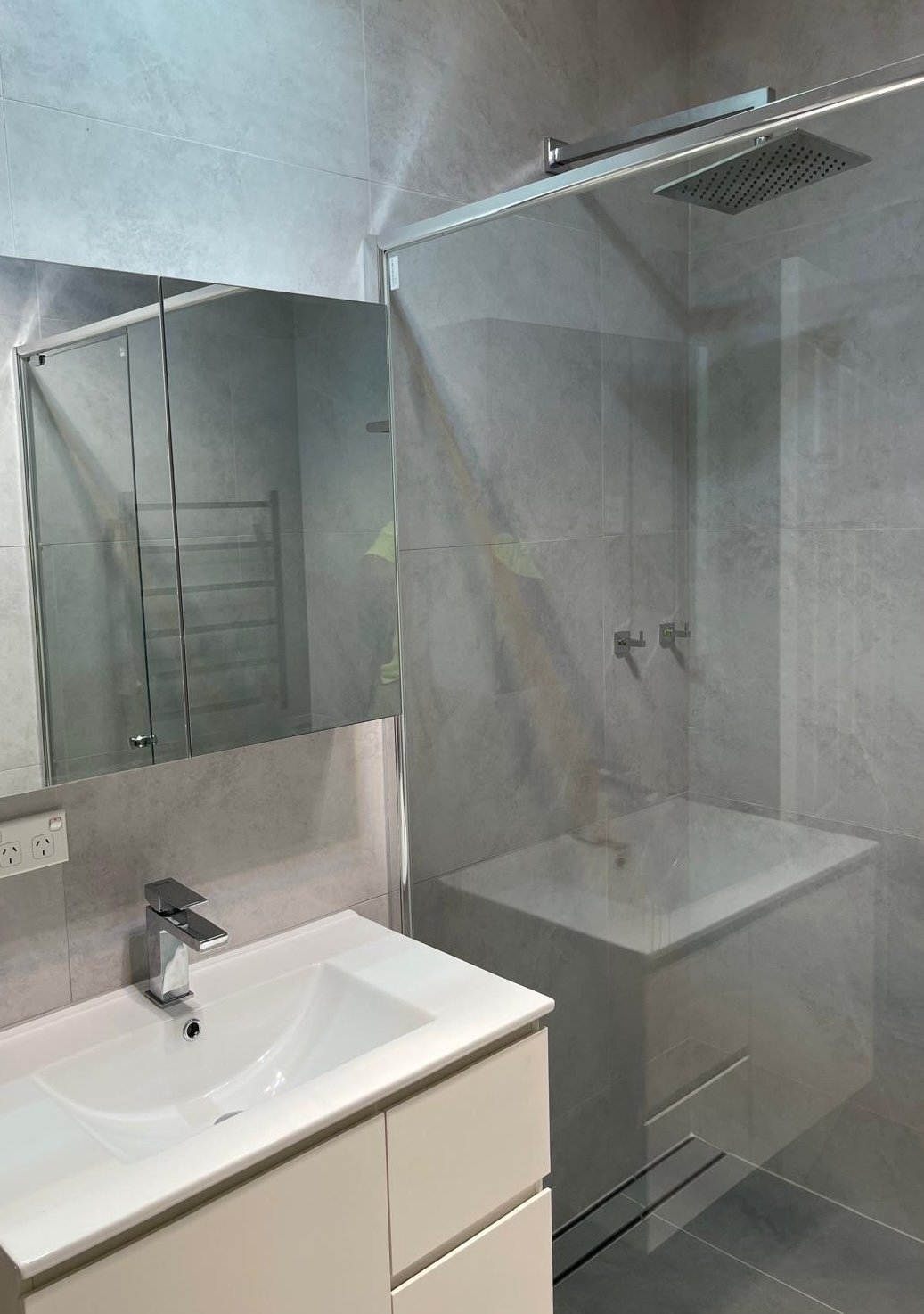 Completed small ensuite with silver fixtures and floating mirror