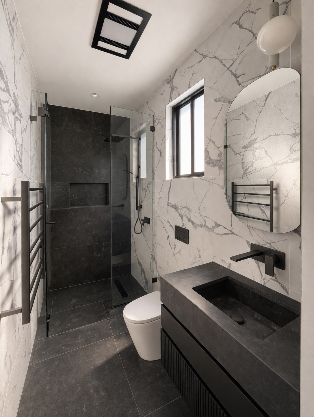 Completed marble ensuite with dark vanity