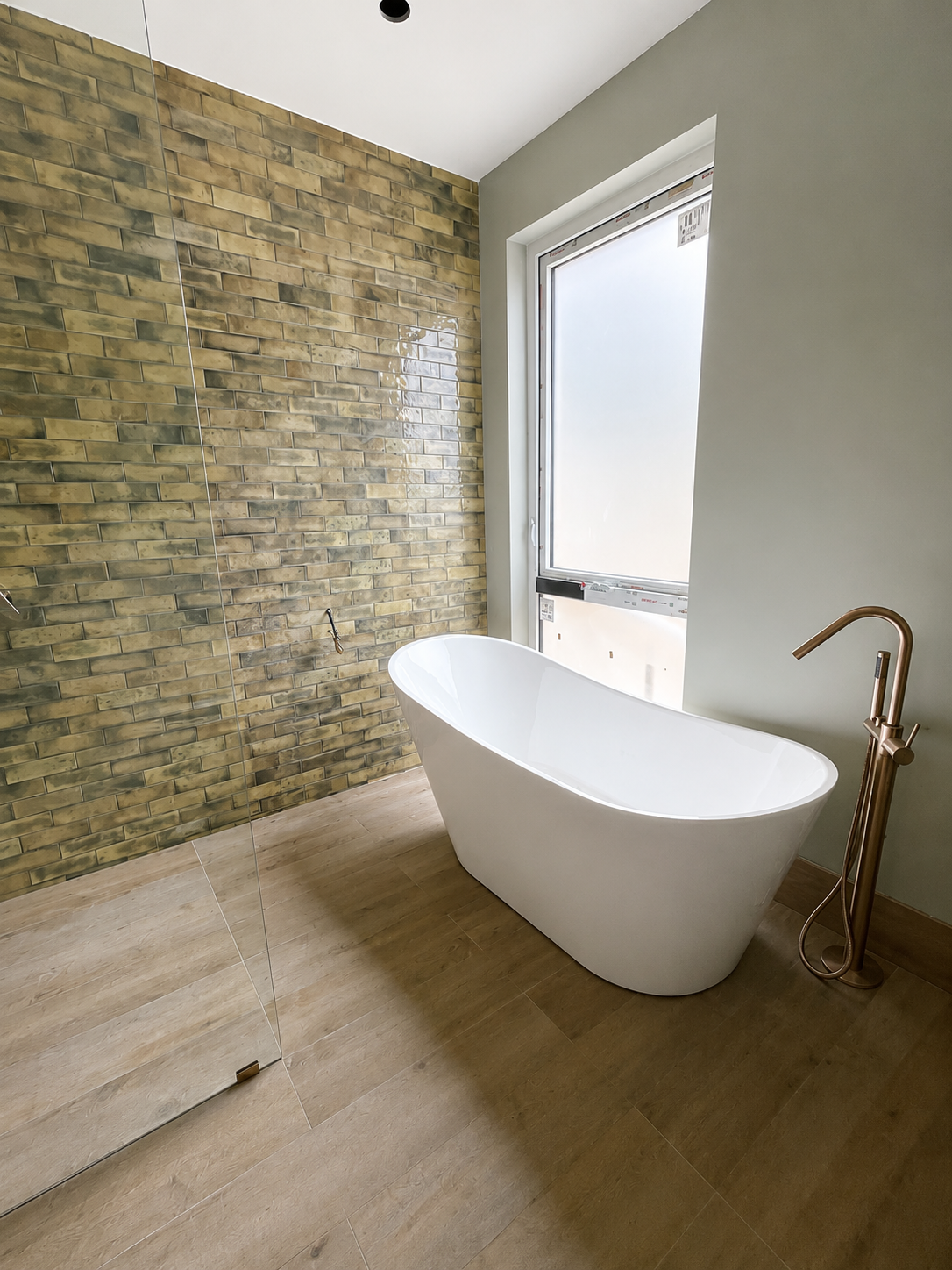 Completed neutral main bathroom with freestanding bathtub