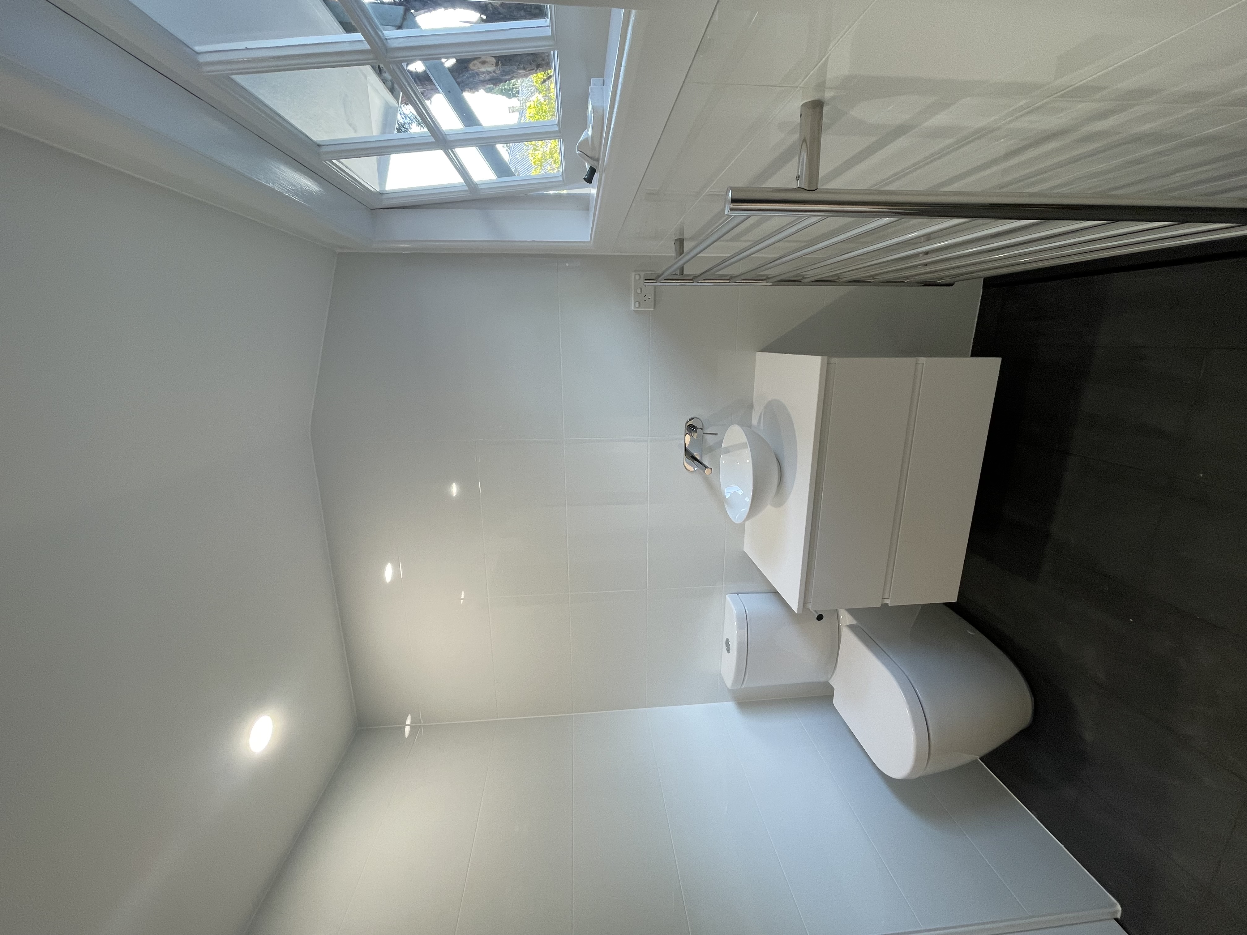Completed small white ensuite bathroom