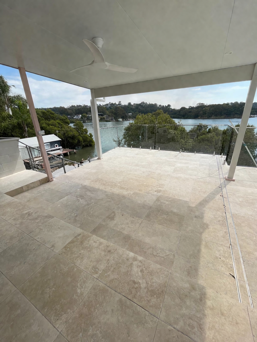 Completed patio tiling with water view