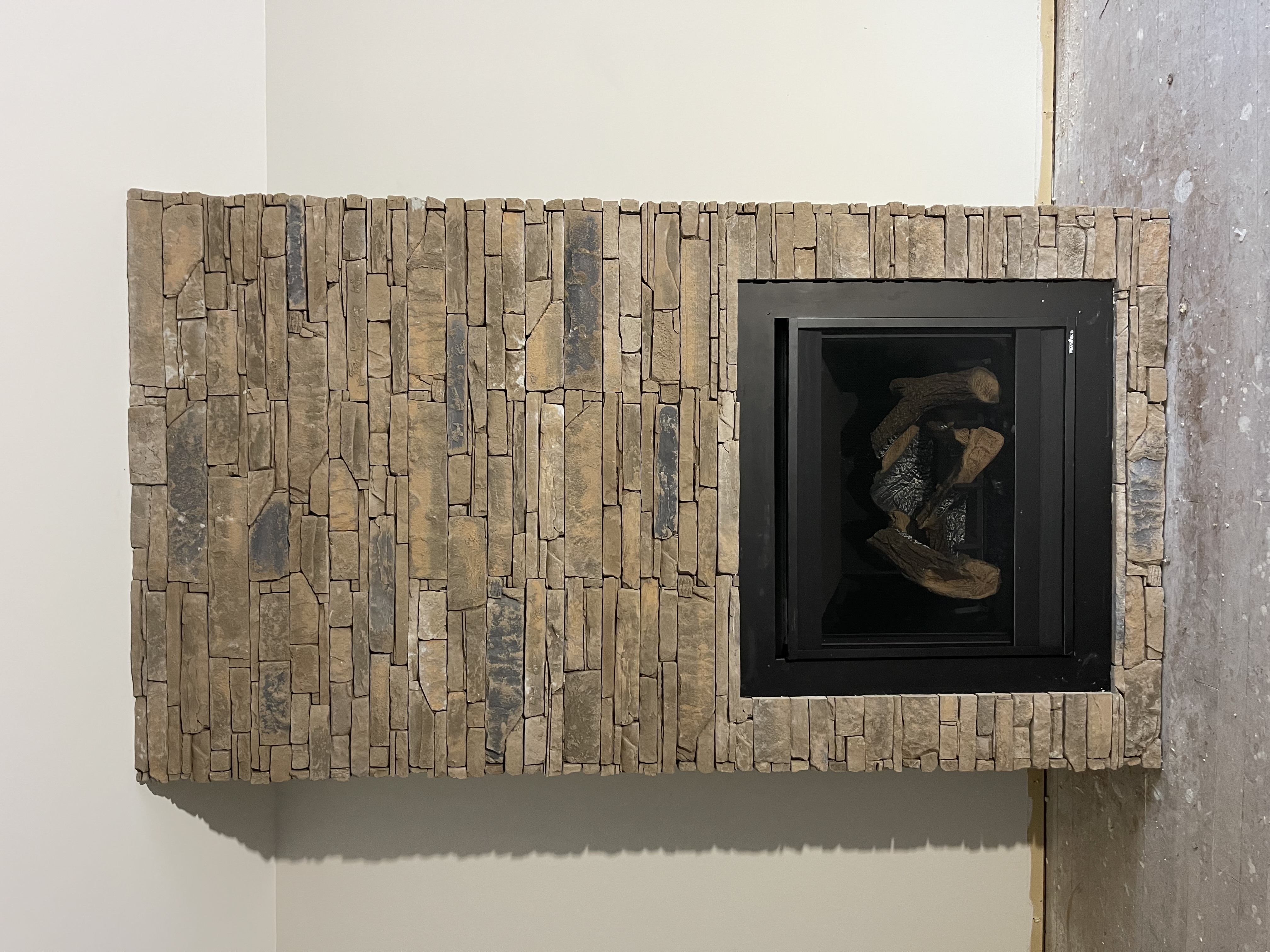 Completed living room fireplace stone feature wall