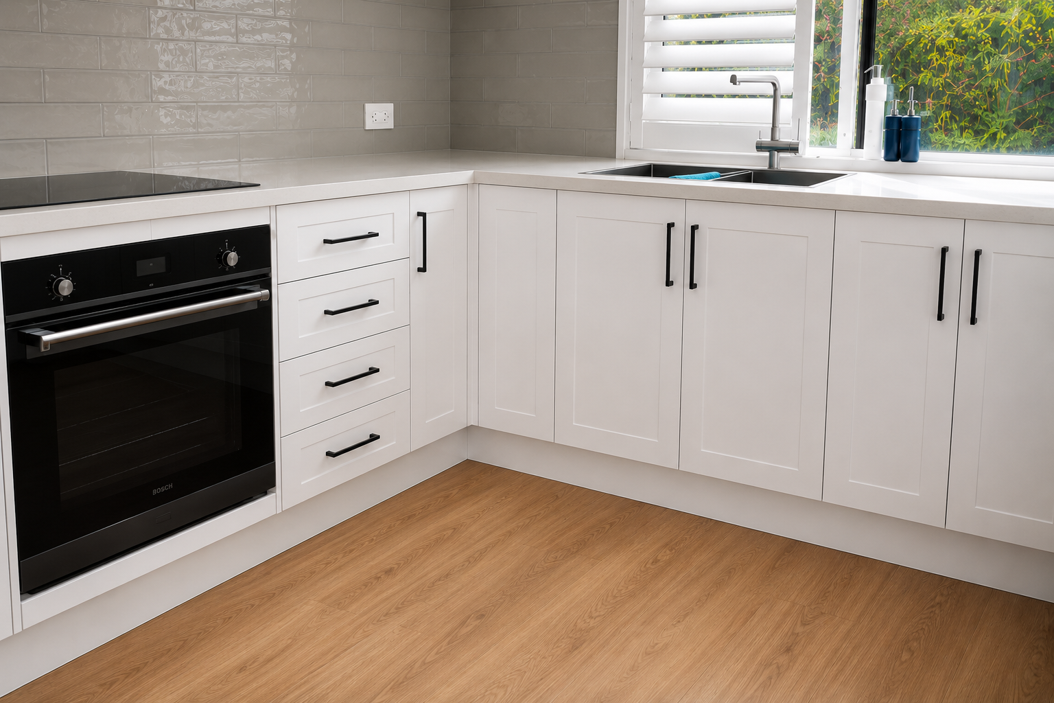Completed WhiteHaven Coastal Hamptons kitchen with grey splashback, crisp white cabinetry and black matte fixtures