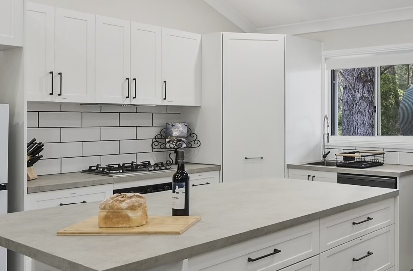 Completed traditional farmhouse kitchen with island benchtop and subway tiles