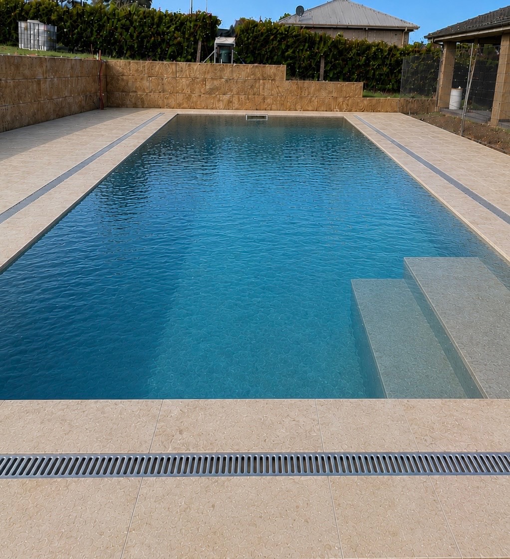 Completed exterior poolside tiling finish with drainage